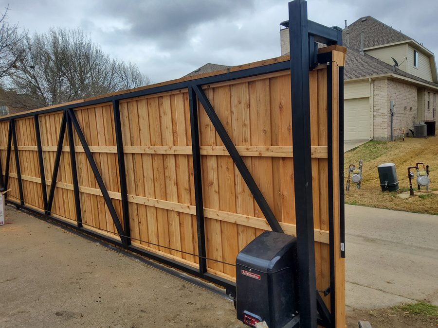 Steel-framed cedar cantilever sliding gate with automatic opener