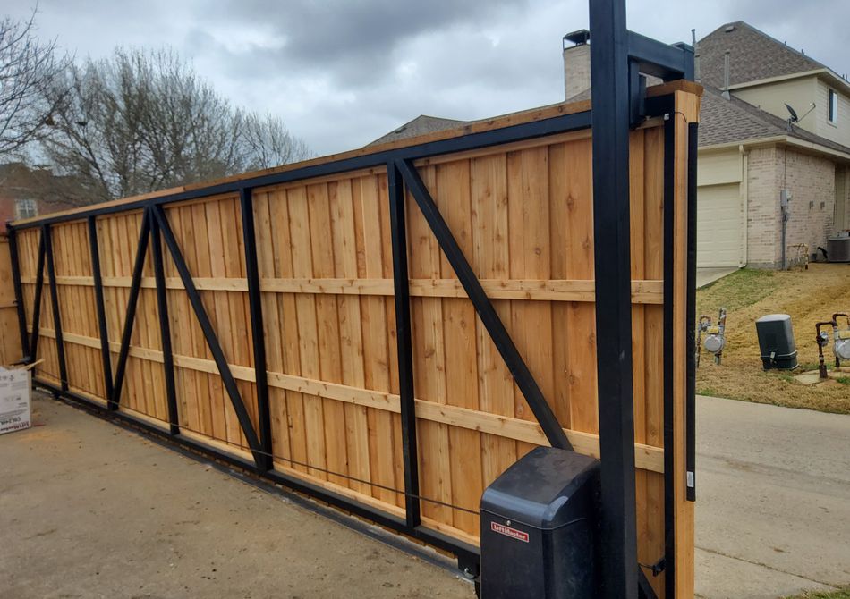 The opener and counterweight arm of a cedar cantilever slide gate, close to the post