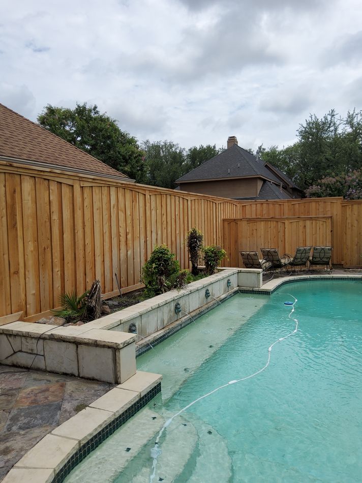 A tall cedar privacy fence wrapping a backyard pool, built by North Texas Future Fence