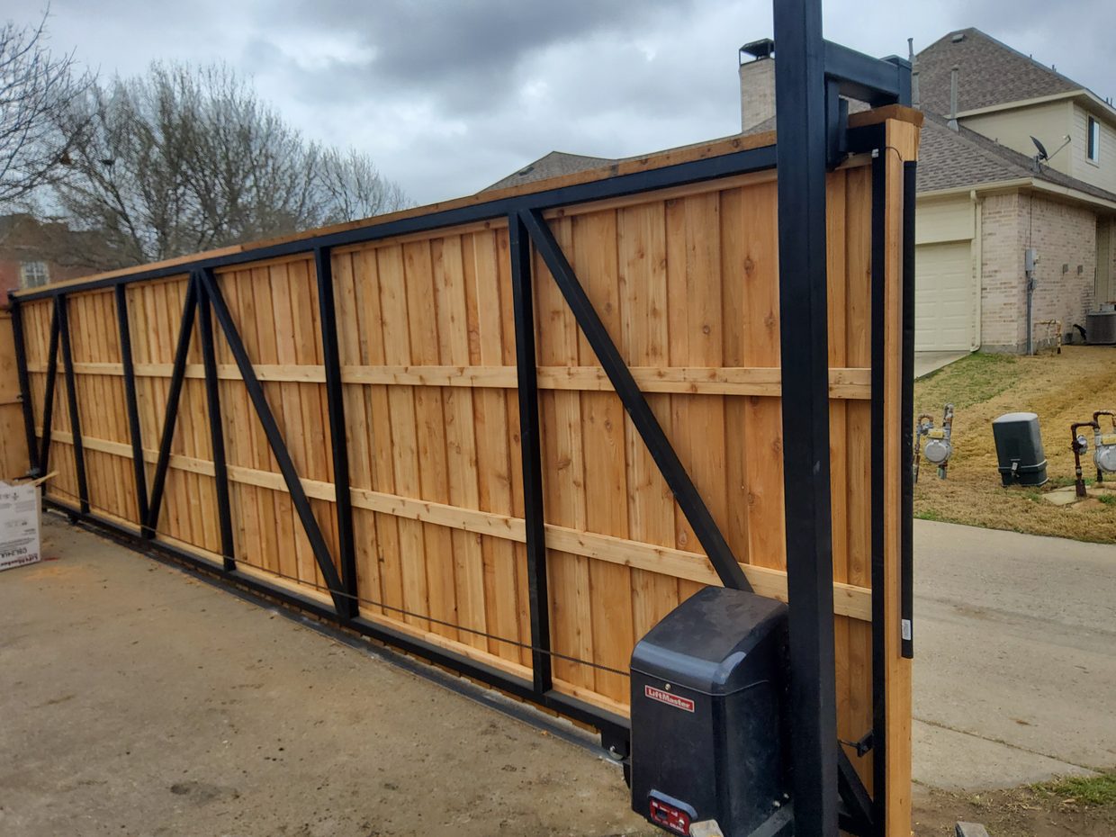 A steel-framed cedar cantilever sliding gate with its automatic opener, built by Future Fence